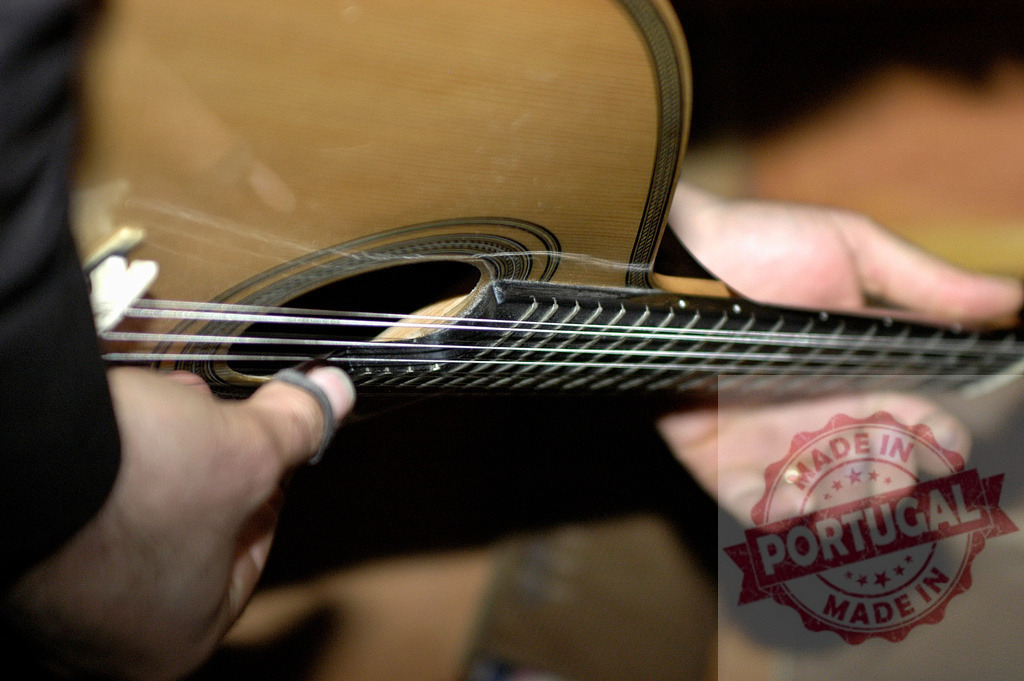 Close-up of hands playing acoustic guitar | Musician playing acoustic guitar strings with fingers and pick - Realized with Pictrs.com