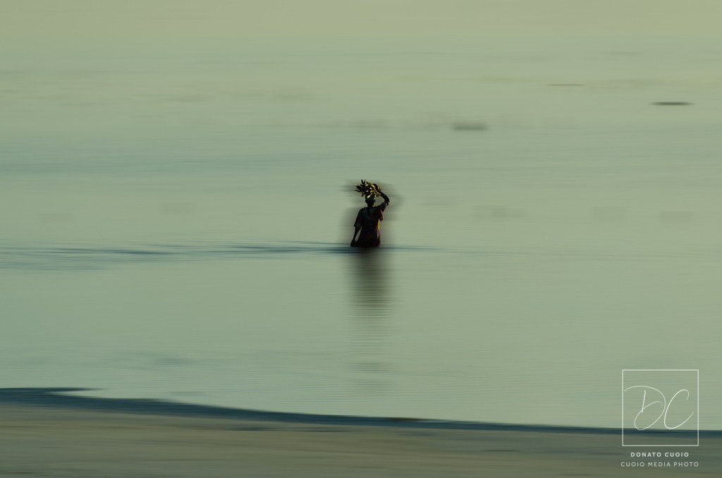 Morning Vibes | Das Bild "Morning Vibes" fängt die friedliche Stimmung eines Sonnenaufgangs auf Sansibar ein. Im Vordergrund ist eine Person zu sehen, die ein morgendliches Bad im Meer genießt. Durch gezielte digitale Bildbearbeitung wird eine Bewegungsunschärfe erzeugt, die die sanfte Müdigkeit des frühen Morgens widerspiegelt und dem Bild eine traumhafte Atmosphäre verleiht.Erlebe die Ruhe und Schönheit eines afrikanischen Morgens mit meinem Fine Art Print. Dieses Kunstwerk bringt die entspannte Stimmung Sansibars direkt in dein Zuhause und lädt zum Träumen ein.Dieses Kunstwerk eignet sich ideal für Liebhaber exotischer Landschaften und bringt die entspannte Atmosphäre eines tropischen Morgens direkt in dein Wohnzimmer oder Büro. - Realisiert mit Pictrs.com