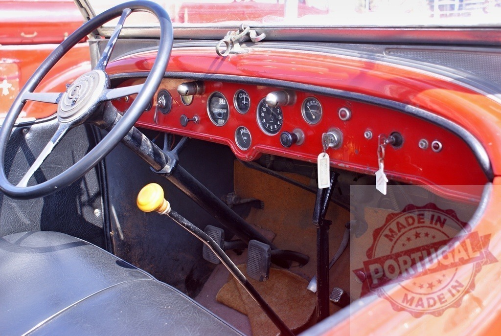 Vintage car interior showing red dashboard and steering wheel | Vintage car interior with a red dashboard, steering wheel, and gear stick, reflecting history of transport - Realized with Pictrs.com