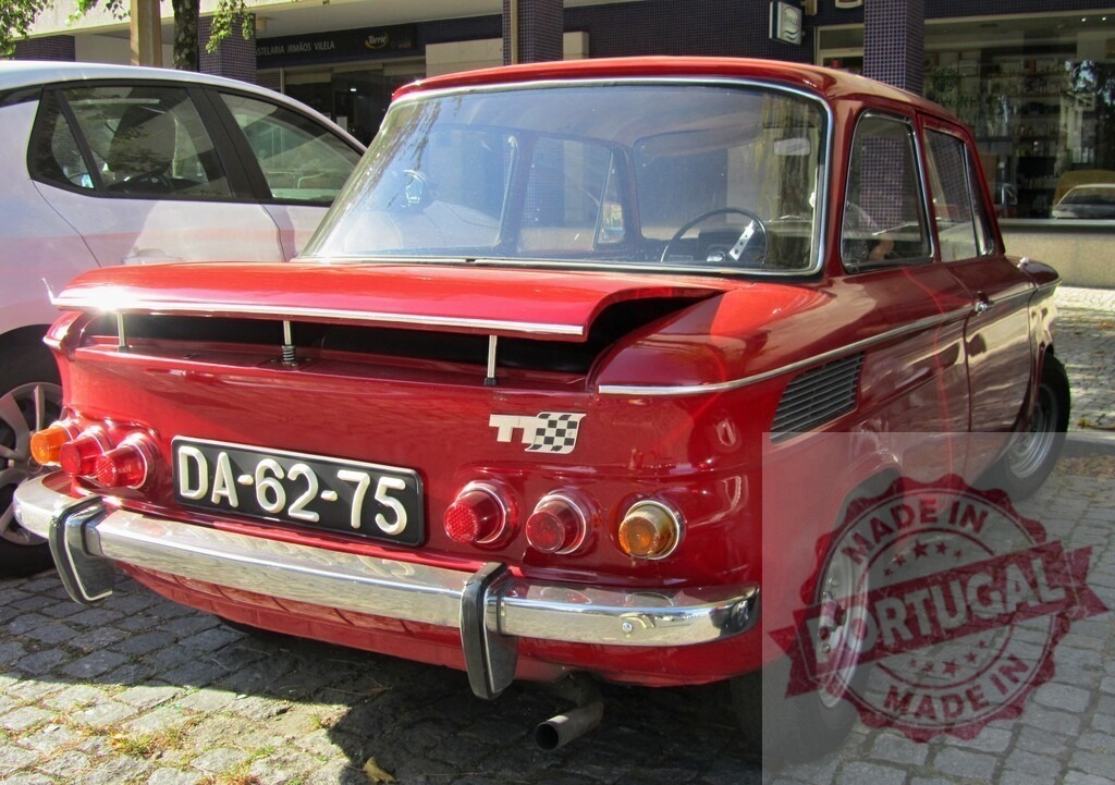 Red NSU Prinz TT parked on cobblestone street, rear view | Classic red NSU Prinz TT car parked on a cobblestone street, showcasing its unique rear design - Realisiert mit Pictrs.com