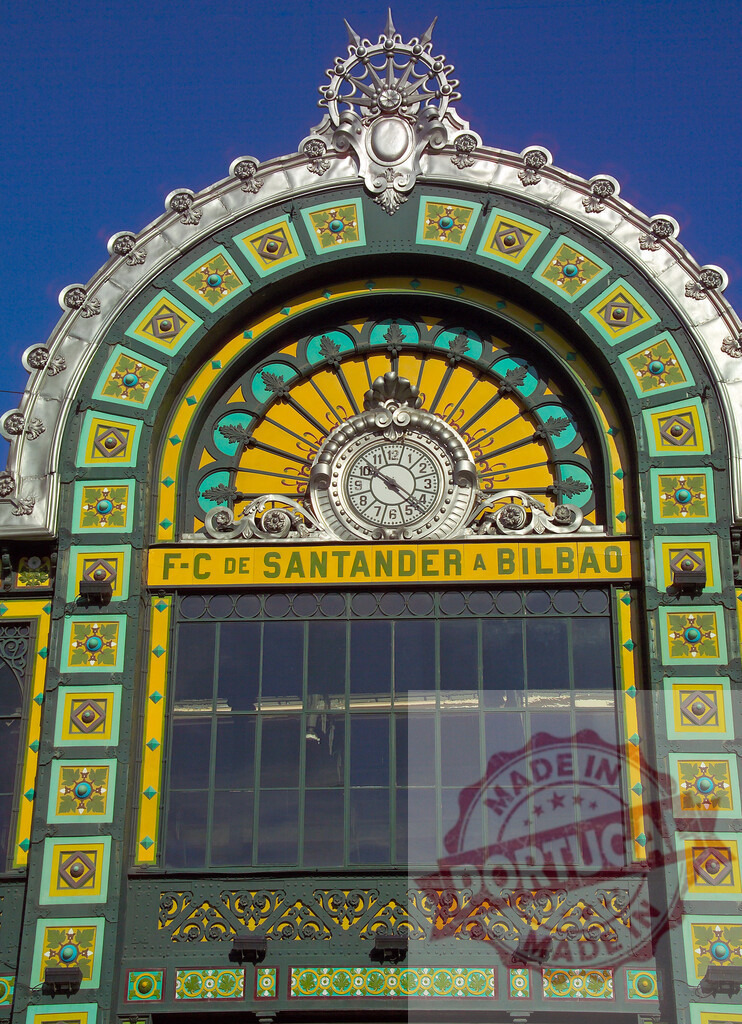 Concordia Station Art Nouveau architecture with clock and facade detail. Spain - Bilbao | Arched Art Nouveau facade of La Concordia Station in Bilbao, Spain, featuring ornamental clock and bright colors - Realized with Pictrs.com