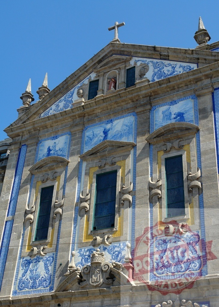 Capela das Almas church facade with traditional azulejo tiles | Capela das Almas church facade featuring blue and white azulejo tiles on a sunny day - Realized with Pictrs.com