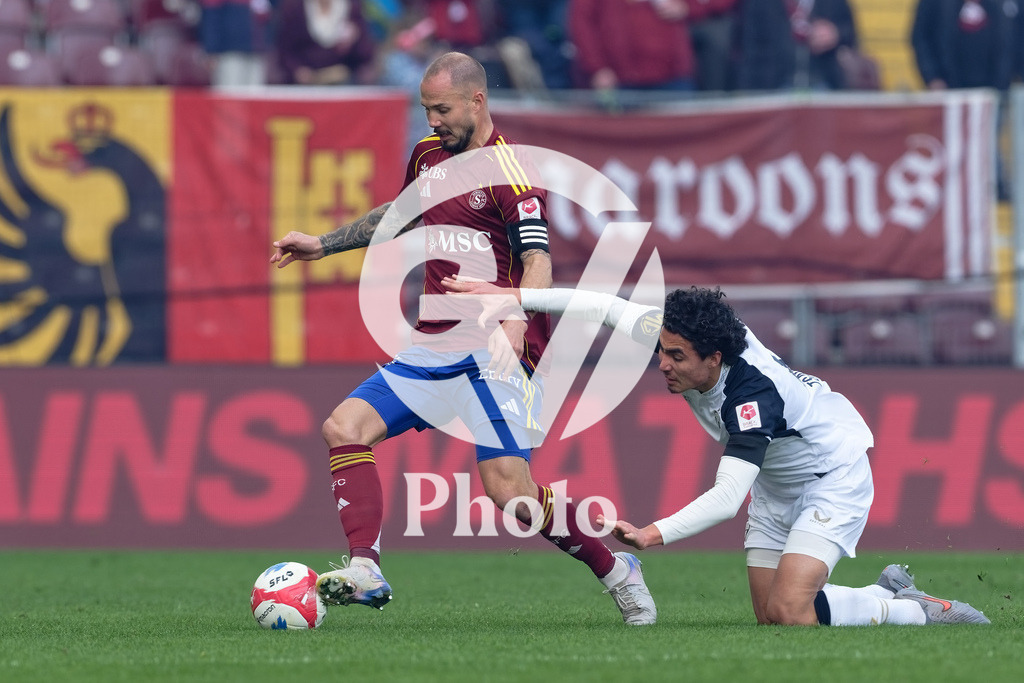 Brack Super League - Servette FC v FC Zurich | Steve Rouiller (4 Servette FC) in action (close up) under pressure of Cheveyo Tsawa (6 FC Zurich)  during the Brack Super League match between Servette FC and FC Zurich at Stade de Geneve in Geneva, Switzerland