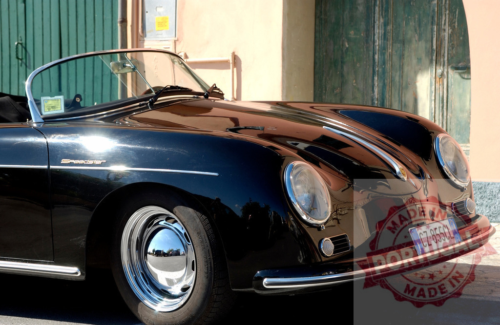 Black Porsche 356 Speedster reflecting sunlight parked in front of a colorful building | Shiny black Porsche 356 Speedster reflecting sunlight parked in front of a colorful building with green wooden door - Realized with Pictrs.com