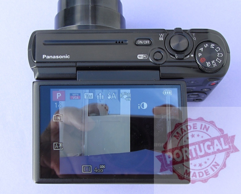 Panasonic Lumix digital camera with LCD screen open | Panasonic digital camera displaying its LCD screen with settings and controls visible - Realized with Pictrs.com