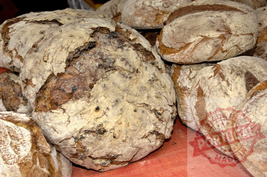 Rustic artisan bread loaves fresh baked at market | Rustic artisan bread loaves display their textured crusts dusted with flour - Realized with Pictrs.com