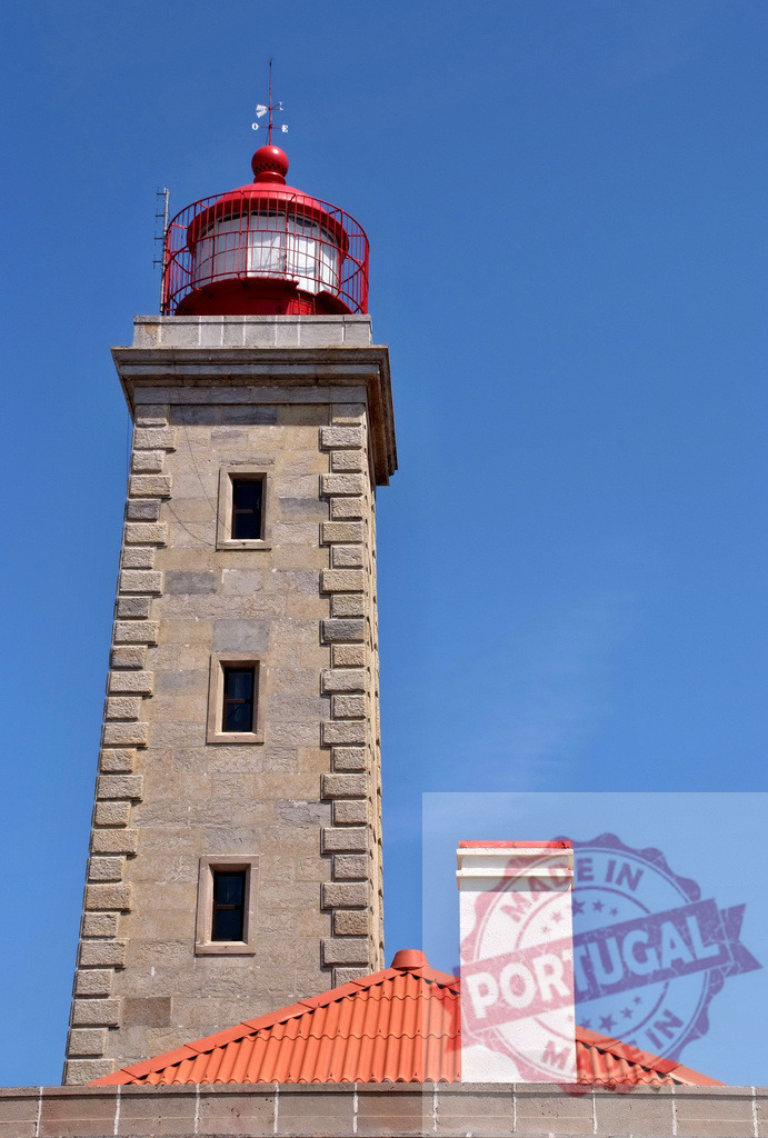 Farol de Santa Marta lighthouse against blue sky | Farol de Santa Marta, a stone lighthouse with a red roof, guiding ships along the coast - Realized with Pictrs.com