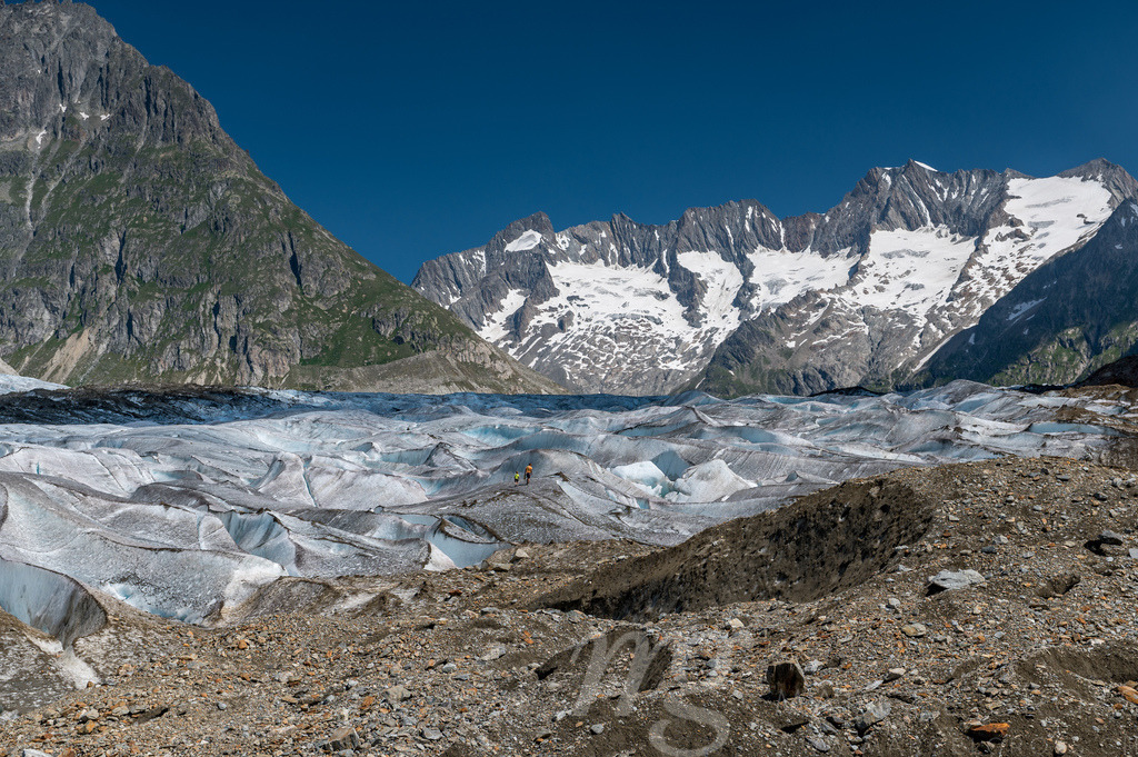 a man and his son on the ice of the mighty Aletschgletscher | Die ideale Geschenkidee für Naturliebhaber. Naturbilder von Marcel Gross Photography für ihr Zuhause in den verschiedensten Formaten und Materialien. - Realisiert mit Pictrs.com