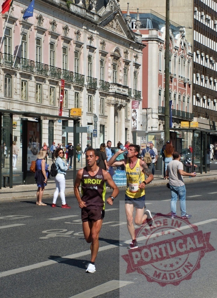 Runners competing in Lisbon marathon city street | Marathon runners competing along a city street in Lisbon, Portugal - Realized with Pictrs.com