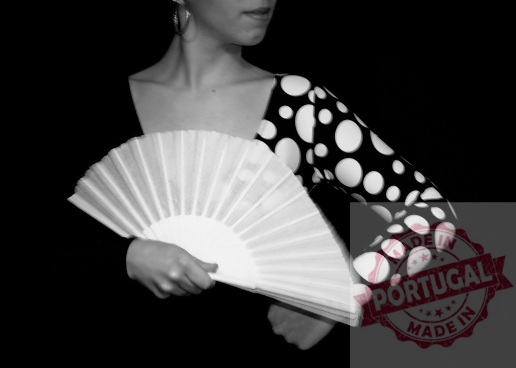 Woman holding fan, dancing flamenco with polka dot sleeve | Woman holding a white fan, performing flamenco in a polka dot dress on a black background - Realized with Pictrs.com