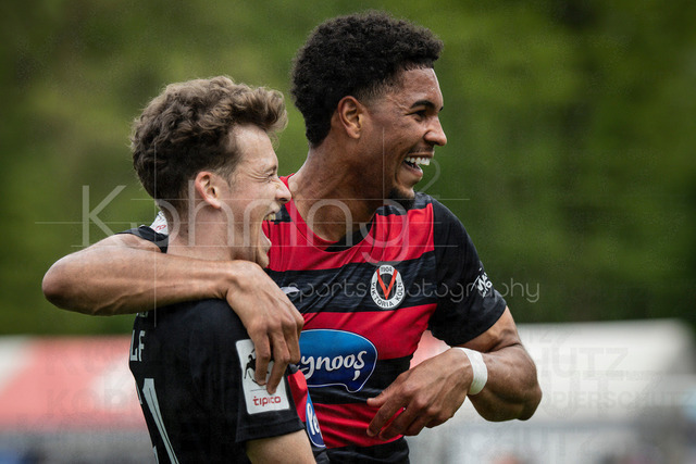 Viktoria Koeln vs. SV Wehen Wiesbaden, 11.04.2026 | KOELN, GERMANY - APRIL 11, 2026:  Lucas Wolf (Viktoria Köln, 21, on the left) celebrates scoring his team's first goal with teammate Benjamin Zank (Viktoria Köln, 23) during the 3rd division match between Viktoria Koeln vs. SV Wehen Wiesbaden at the Sportpark Hoehenberg on matchday 7 on April 11, 2026 in Koeln, Germany. DFL REGULATIONS PROHIBIT ANY USE OF PHOTOGRAPHS AS IMAGE SEQUENCES AND/OR QUASI-VIDEO.