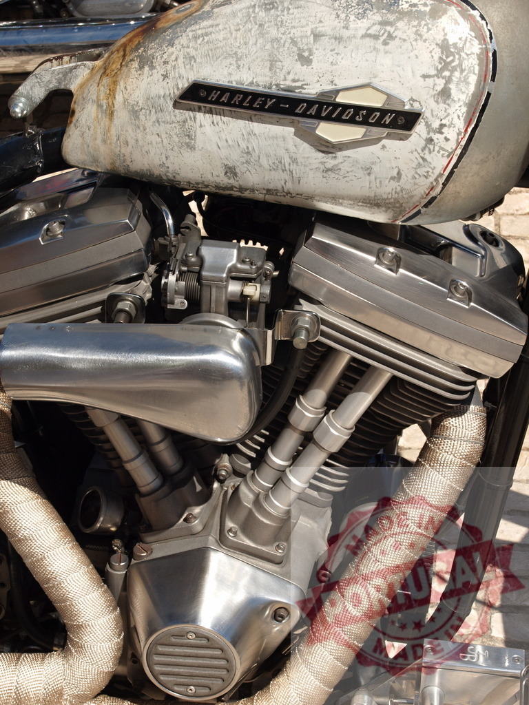 Harley-Davidson motorcycle engine with weathered fuel tank | Harley-Davidson V-twin engine and a distressed fuel tank with chrome details - Realized with Pictrs.com