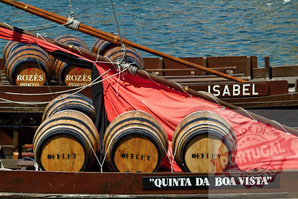 Rabelo boat transporting Offley, Rozès port wine barrels | Traditional rabelo boat carrying port wine barrels along the Douro River in Porto, Portugal - Realized with Pictrs.com