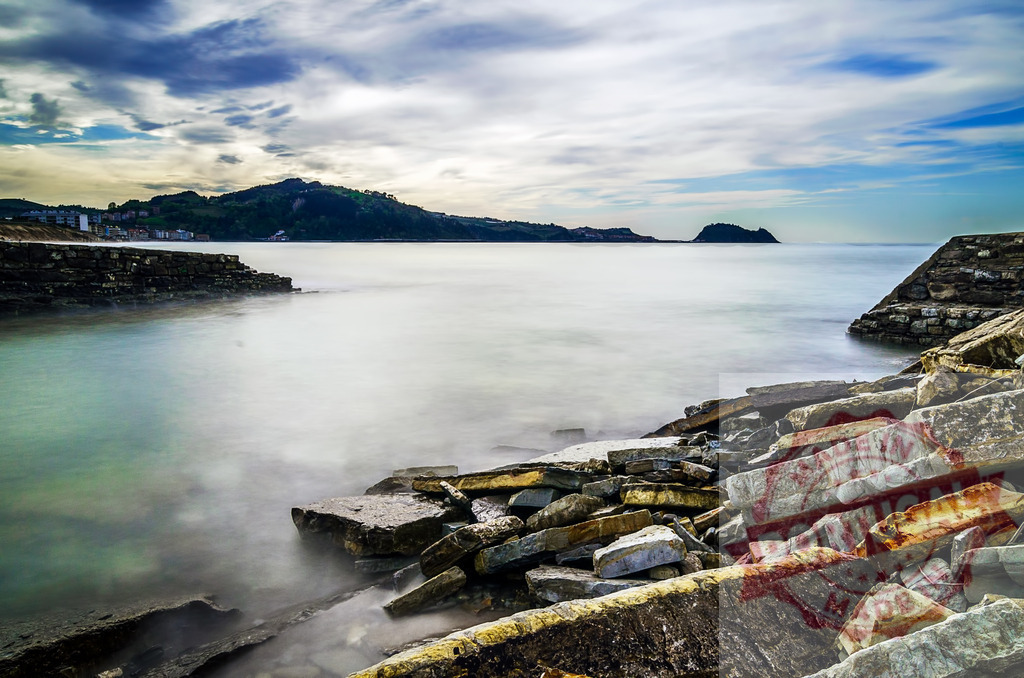 Coastal landscape with long exposure water and rocky shore | Coastal landscape with a tranquil, long exposure sea creating a serene and timeless atmosphere - Realized with Pictrs.com