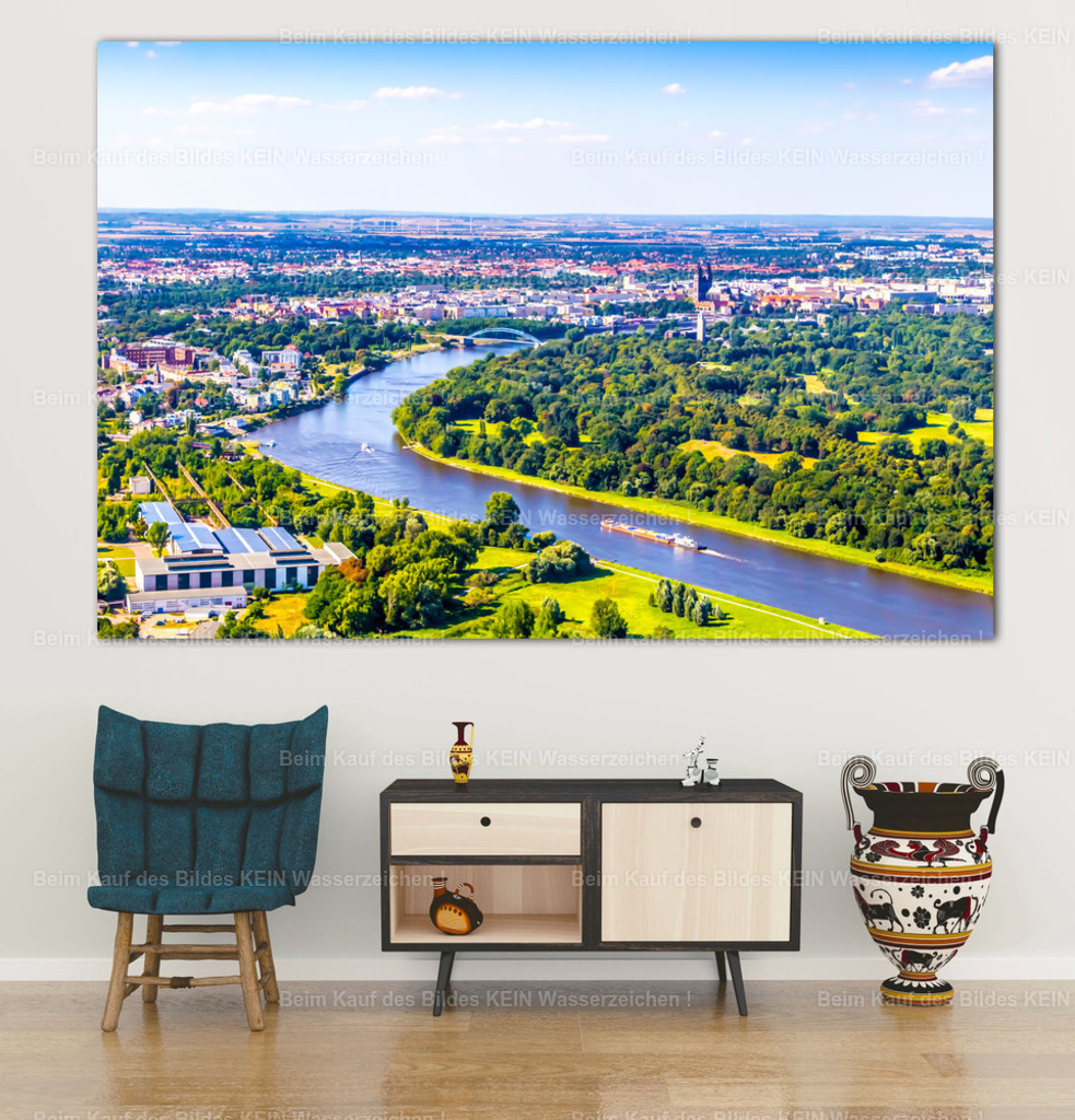 Luftbild Magdeburg Buckau _ Elbe Aquarell-2170_4832 wall_office | Die Elbe schlängelt sich durch die grüne Flusslandschaft Magdeburgs. Dichte Baumkronen, weitläufige Wiesen und der Blick auf die Stadtsilhouette verbinden sich zu einem weiten Panorama, das die natürliche und städtische Seite der Elbestadt zugleich zeigt. Ein Frachtschiff auf dem Fluss unterstreicht den besonderen Charakter dieser Landschaft.Als großformatige Leinwand bringt dieses Motiv Ruhe, Weite und viel Grün in den Wohnbereich. Die Kombination aus blauem Wasser, sattgrünen Uferbereichen und dem hellen Sommerhimmel passt besonders gut zu modernen, natürlich eingerichteten Räumen. Das Panorama wirkt über einer Couch ebenso wie im Büro oder in einem Empfangsbereich.Das Bild ist Teil meines eigenen Luftbildarchivs und als Wandbild auf Leinwand oder Acrylglas erhältlich. Für alle, die Magdeburg nicht nur mit seinen bekannten Bauwerken verbinden, sondern auch die reizvolle Flusslandschaft der Stadt schätzen. - Realisiert mit Pictrs.com