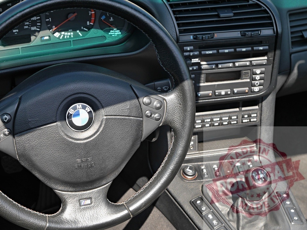 BMW E36 M-Sport interior with manual transmission | BMW E36 M-Sport dashboard, steering wheel, and manual shifter inside a classic car - Realisiert mit Pictrs.com