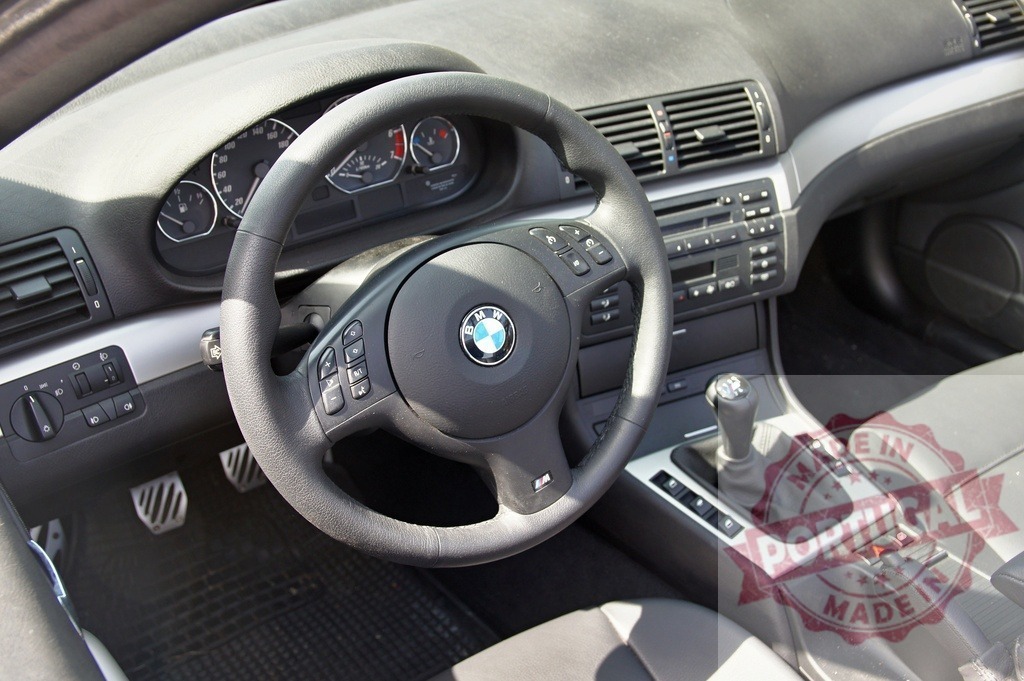 BMW E46 car interior with dashboard and steering wheel | BMW E46 car interior showing dashboard, steering wheel, and manual transmission - Realized with Pictrs.com