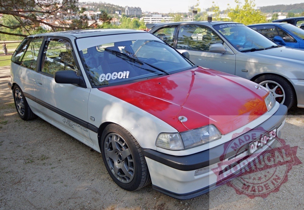 Honda Civic hatchback modified with red hood and VTEC branding | Tuned Honda Civic hatchback with a contrasting red hood parked outdoors - Realized with Pictrs.com