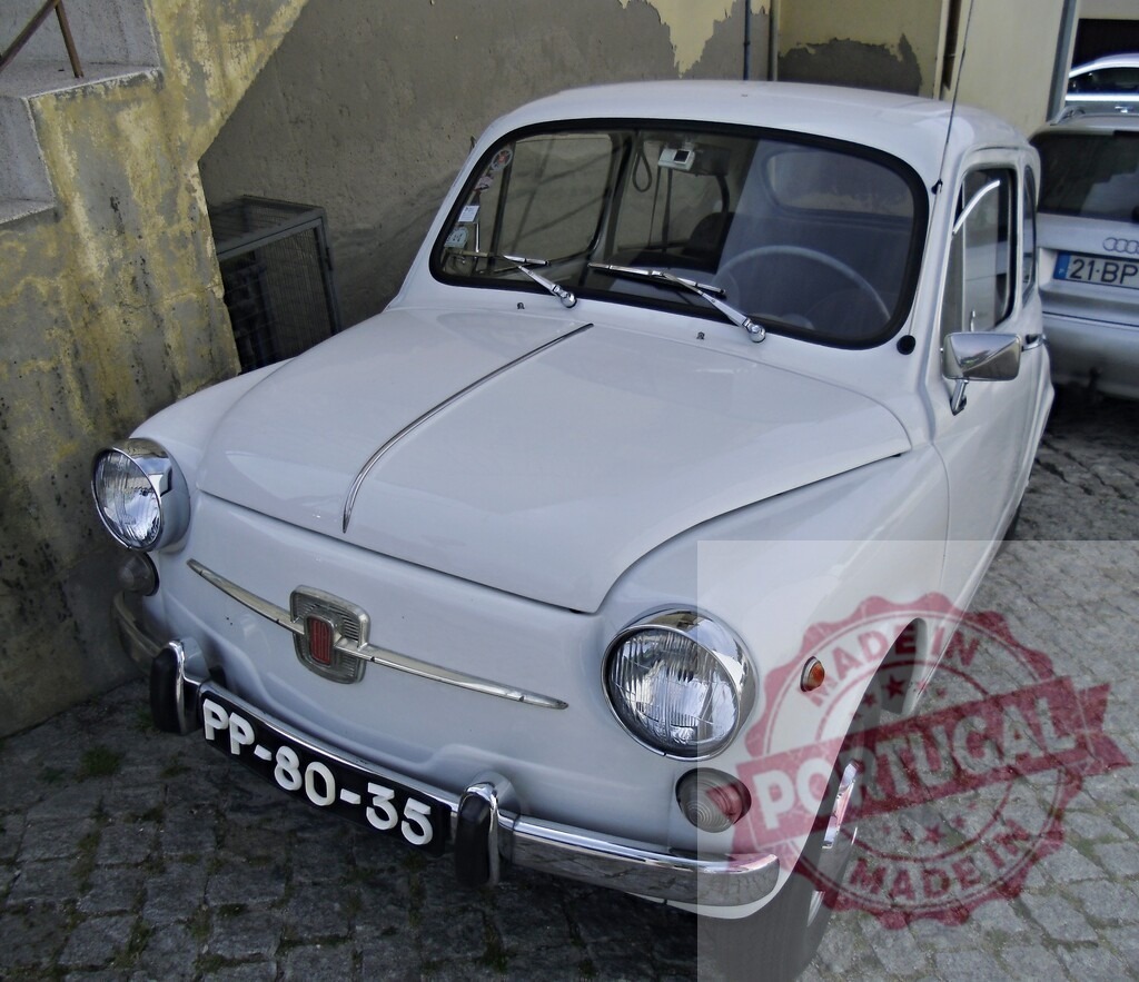 Fiat 600 vintage compact car on cobblestone street | White Fiat 600 classic automobile parked outdoors on a historic cobblestone road - Realized with Pictrs.com