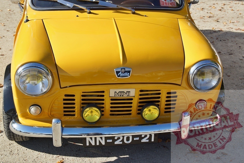 Yellow Austin Mini Cooper classic car front view | Yellow Austin Mini Cooper vintage car parked outdoors displaying its classic design - Realized with Pictrs.com