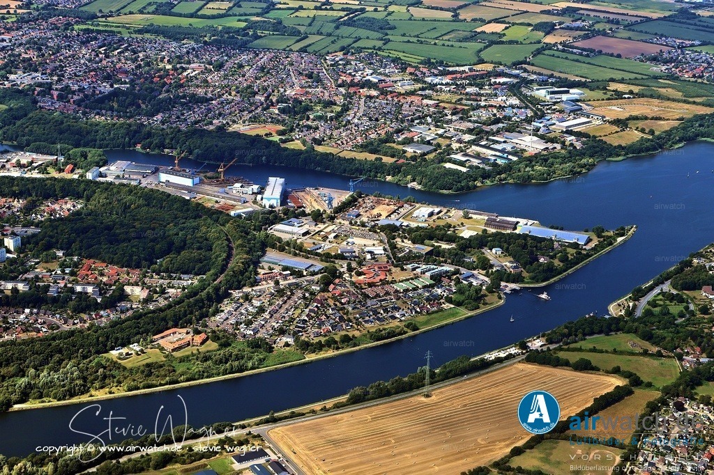 Luftbild Rendsburg - Die Geschichte von Nobiskrug beginnt offiziell im Jahr 1905 | Die Geschichte von Nobiskrug beginnt offiziell im Jahr 1905, als Otto Storck die Schiffswerft in Rendsburg gründete. Allerdings reichen die Wurzeln des Unternehmens bereits zurück auf das Jahr 1895, als der Nord-Ostsee-Kanal eröffnet wurde und die Lebensader der Werft wurde. Die Werft entwickelte sich zu einer international renommierten Einrichtung, spezialisiert auf den Bau individuell angepasster Luxusyachten.