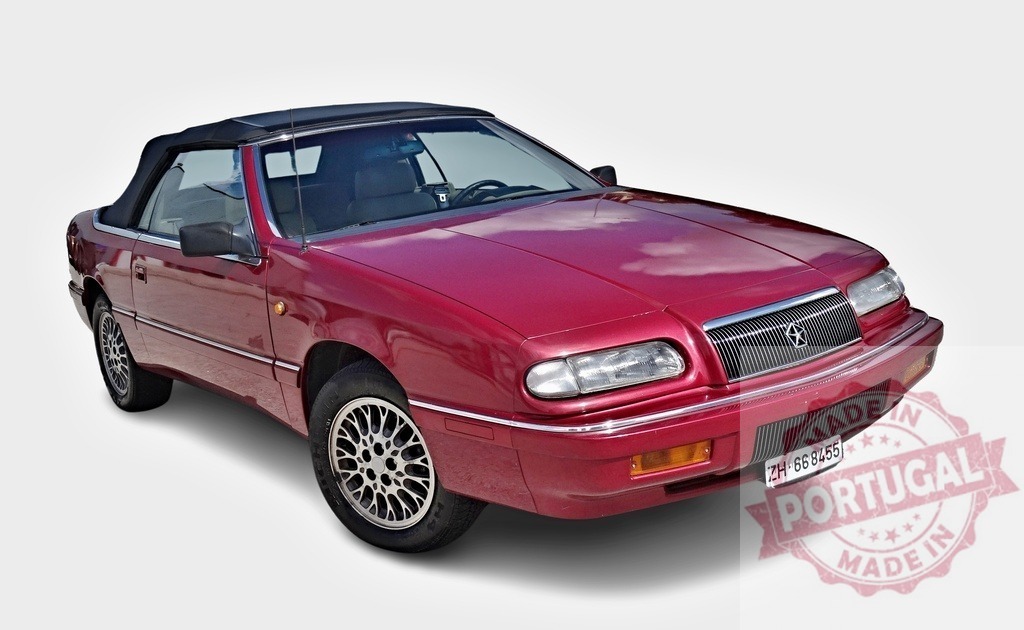 Red Chrysler LeBaron convertible parked with open roof showing alloy wheels | Classic Chrysler LeBaron convertible parked with open roof, showing alloy wheels, reflecting sky on its polished paint - Realisiert mit Pictrs.com