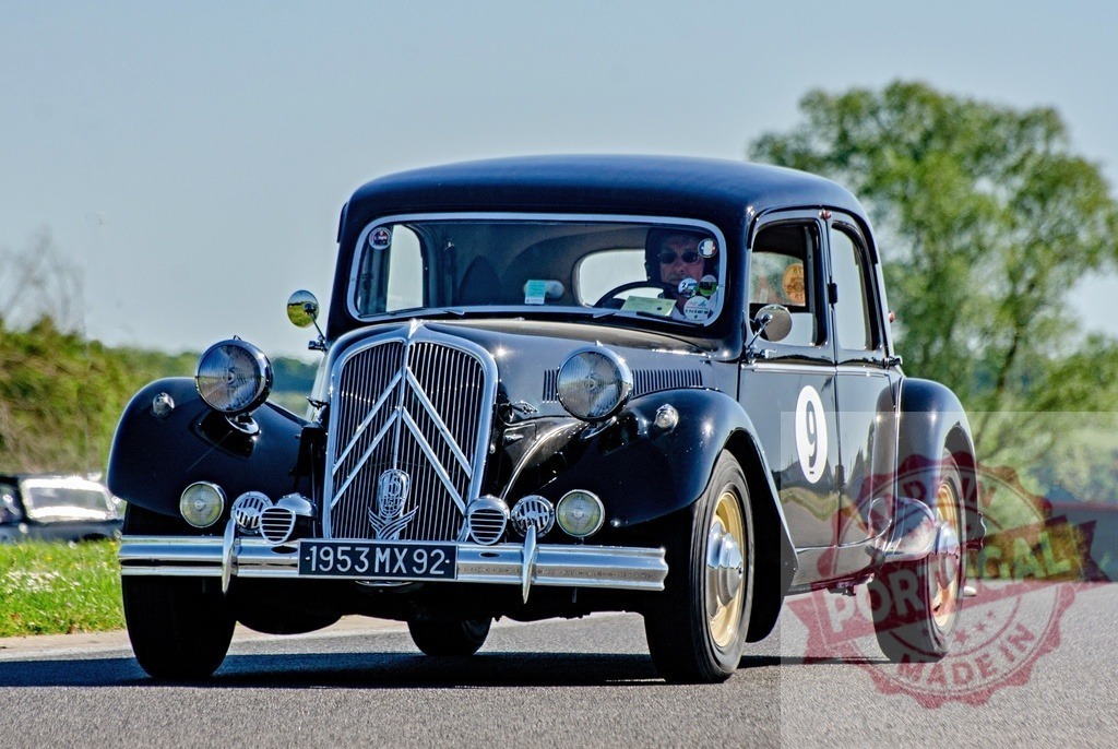 Citroën Traction Avant car on road at vintage rally | Black classic Citroën Traction Avant driving on an asphalt road during a race event - Realized with Pictrs.com