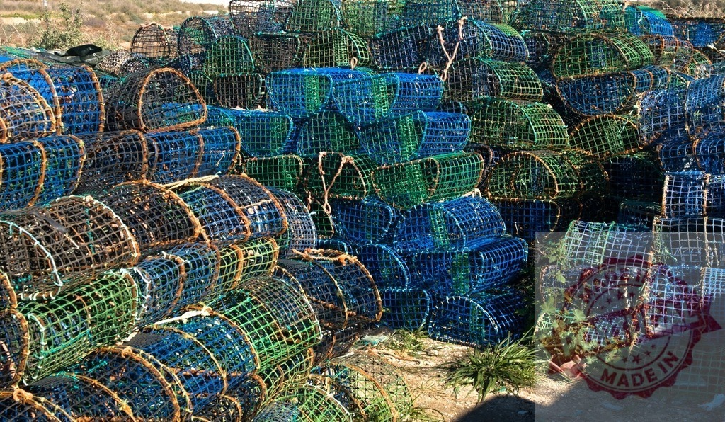 Stacked fishing pots ready for coastal seafood harvesting | Fishing pots are stacked, waiting to be used for commercial seafood catch - Realisiert mit Pictrs.com