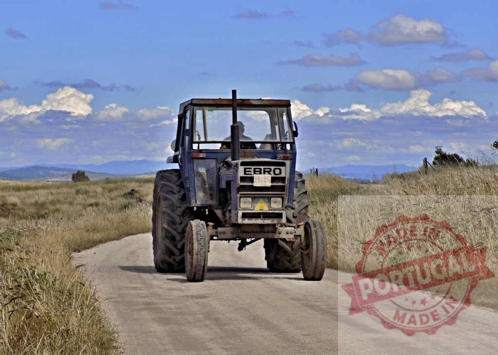 Ebro tractor driving on rural dirt road | Ebro tractor driving on a dusty dirt road through dry fields under blue sky - Realisiert mit Pictrs.com
