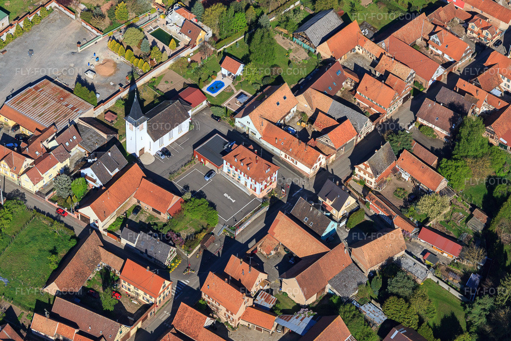 Aerial view: Village center with church Mulhausen in Mulhausen in the state Bas-Rhin, France. – Photo: IMG_099458.jpg taken on 04/30/2017 by Werner Riehm/FLY-FOTO.com – Resolution of the original: 4703 x 3135 px