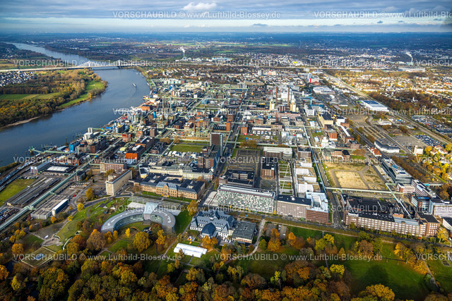 Leverkusen231100620BayerLeverkusen Bayer AG | Luftbild, Chempark Leverkusen Chemiepark (ehemals Bayerwerk) am Fluss Rhein, Industrieanlage, halbrundes Gebäude der Konzernzentrale Bayer AG, Bayer Kasino, Himmel und Fernsicht, umgeben von herbstlichen Laubbäumen, Wiesdorf, Leverkusen, Rheinland, Nordrhein-Westfalen, Deutschland