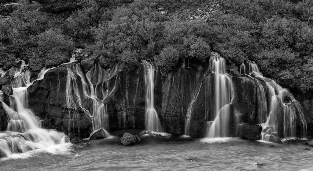 island-2019-193-02 | Der Name Hraunfossar bedeutet „Lavafälle“. Diese Wasserfälle im Westen Islands sind wohl einzigartig: Über eine Länge von einem Kilometer stürzen unzählige Wasserläufe direkt aus einem Lavafeld in den Fluss Hvítá. - Realisiert mit Pictrs.com
