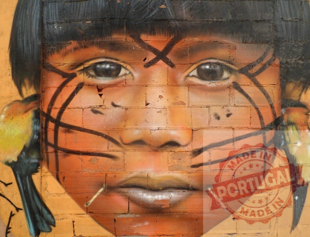 Indigenous child portrait street art mural on brick wall | Indigenous child portrait mural painted on a textured brick wall with face paint elements and birds - Realized with Pictrs.com
