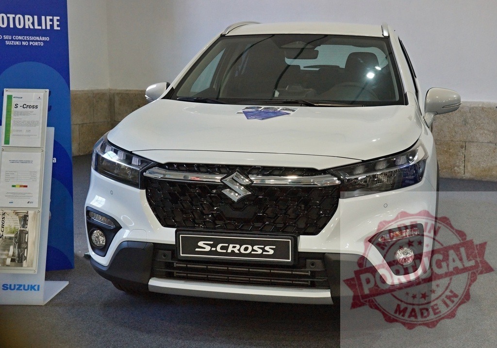Suzuki S-Cross subcompact crossover SUV in showroom | White Suzuki S-Cross car on display, representing automotive sales and new vehicle models - Realized with Pictrs.com