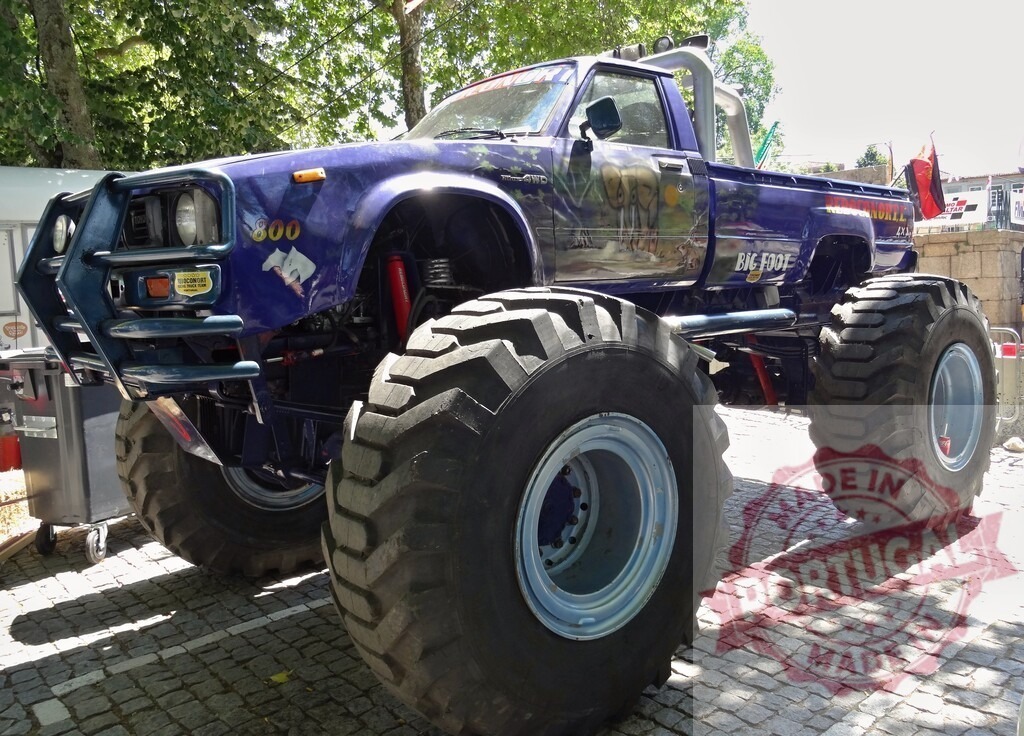 Bigfoot monster truck standing on a cobblestone street | Customized Toyota Bigfoot monster truck with large tires standing on a cobblestone street - Realized with Pictrs.com