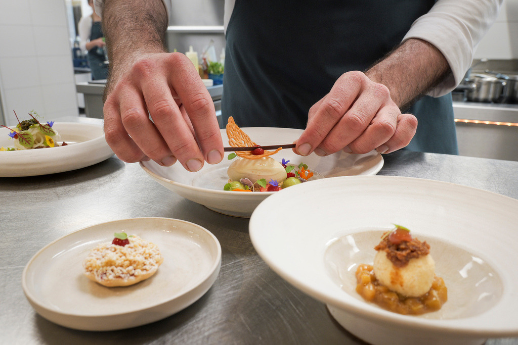 Philippins | Rutesheim - Gastro der Koch Tim Striegel mit den von ihm zubereiteten Speisen in dem kürzlich renovierten Café und der Konditorei Philippins. Im Bild: Grosse Teller: Mandel financier mit basilikum creme, rhabaraba sorbet erdbeere - Mittlere Teller rhabarba ragout mit topfenknödel und vanille Soße - Kleine Teller Erdbeere Tartlette mit Vanille-creme, und weissenschokoladen Streusel - Realisiert mit Pictrs.com