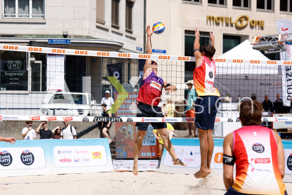 Obi BeachTour 2026 - Basel | BASEL, SWITZERLAND - JULY 18: FLORIAN BREER (SUI) attack / spike against LUC EMANUEL FLÜCKIGER (SUI) block during the Obi BeachTour 2026 match between DILLIER / FLÜCKIGER (SUI) and BREER / KÄLIN (SUI) at Barfüsserplatz on July 18, 2026 in Basel, Switzerland. - Realisiert mit Pictrs.com