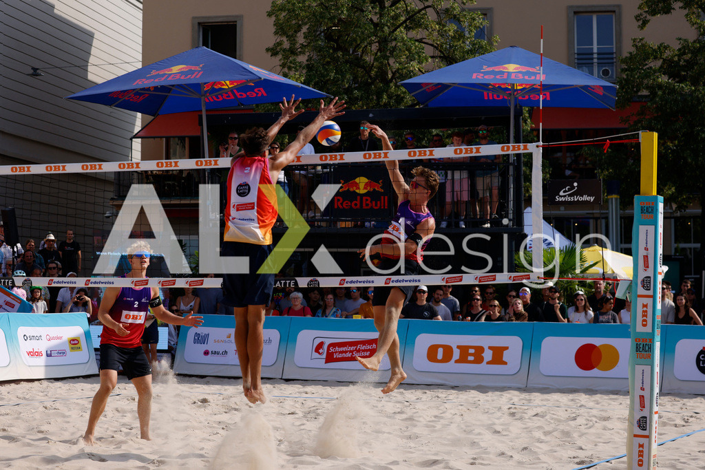 Obi BeachTour 2026 - Basel | BASEL, SWITZERLAND - JULY 19: FLORIAN BREER (SUI) attack / spike against LUC EMANUEL FLÜCKIGER (SUI) block during the Obi BeachTour 2026 match between DILLIER / FLÜCKIGER (SUI) and BREER / KÄLIN (SUI) at Barfüsserplatz on July 19, 2026 in Basel, Switzerland. - Realisiert mit Pictrs.com
