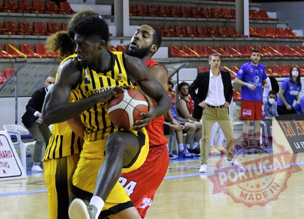 Basketball players competing for ball during a live game | Two basketball players battling for possession of the ball during a competitive match - Realized with Pictrs.com