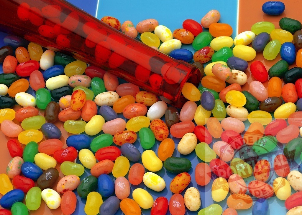 Colorful jelly beans spilling from a red tube | Assorted vibrant jelly beans spilling from a glass tube, creating a colorful sweet background - Realisiert mit Pictrs.com
