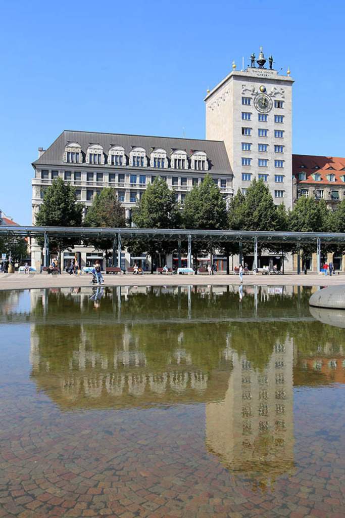 Bildlexikon Leipzig - Bamberger & Hertz - Königsbau - Spiegelung in der Fontäne vor dem Opernhaus | Das Team hinter BILDLEXIKON LEIPZIG bündelt historische wie aktuelle Informationen über die Stadt Leipzig in Text und Bild auf einer Plattform und stellt diese der interessierten Öffentlichkeit zur Verfügung.