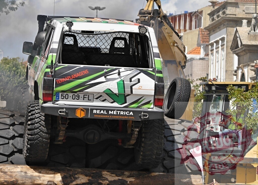 Off-road vehicle overcoming obstacles in an urban environment during a competition | Powerful 4x4 car climbing over tires during an off-road competition in a city setting - Realisiert mit Pictrs.com