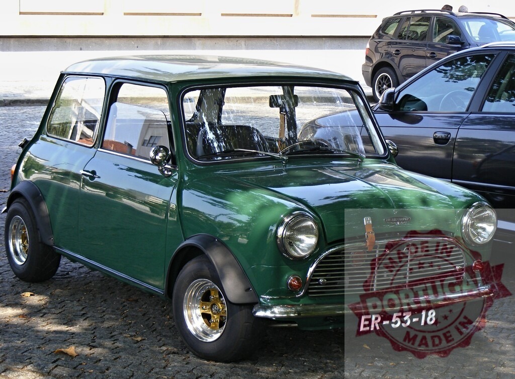 Classic green Mini Cooper shining parked on cobblestone street | Classic green Mini Cooper parked on a cobblestone street, showcasing its timeless design and shiny exterior - Realized with Pictrs.com