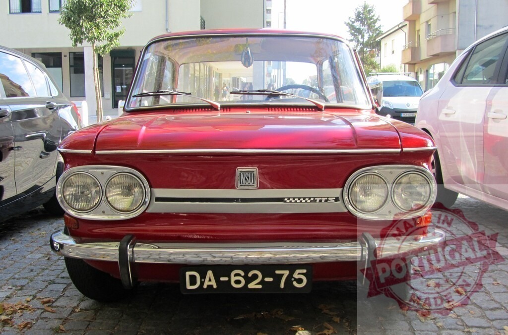 Red NSU Prinz TTS parking on a paved street | Classic red NSU Prinz TTS parked on a paved street, showcasing its vintage design - Realized with Pictrs.com