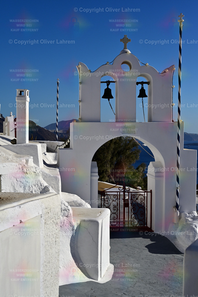 Orthodoxer Glockenturm | Einer der typischen Glockentürme auf der Griechischen Insel Santorin über dem Tor zum Kirchengeländebei strahlend blauen Himmel.