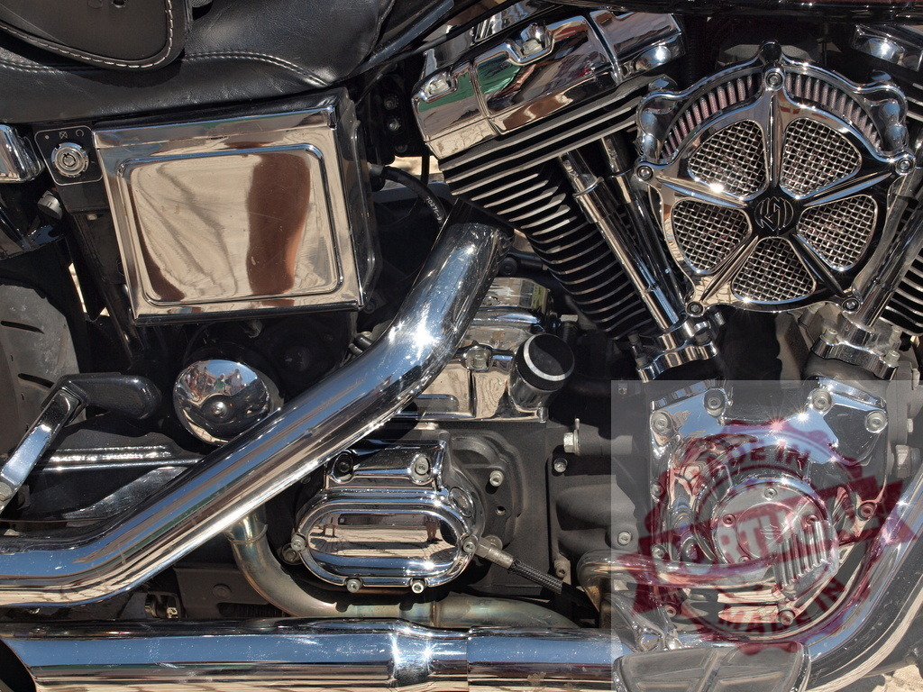 Harley-Davidson V-twin engine with chrome details | Motorcycle engine featuring shiny chrome plating, cylinders, exhaust pipes, and air filter - Realized with Pictrs.com