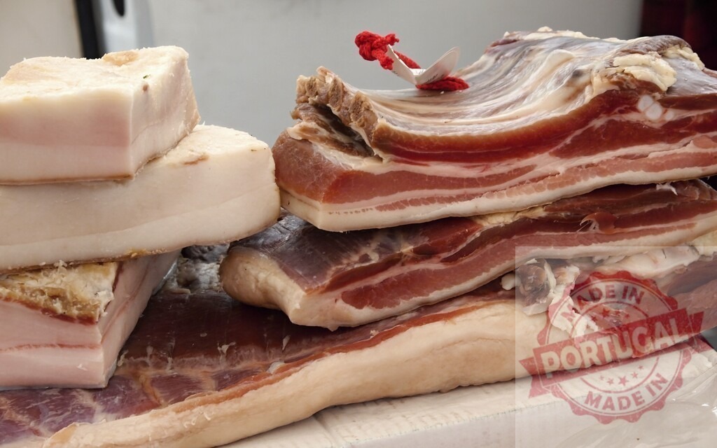 Cured pork belly and fat displaying traditional meat products | Slabs of smoked bacon and salo showing a variety of artisanal cured pork cuts - Realized with Pictrs.com