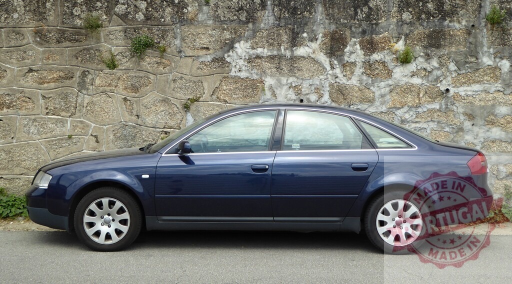 Audi A6 blue sedan car parked against stone wall | Audi A6 blue sedan parked on asphalt street next to an old stone wall, side view - Realisiert mit Pictrs.com