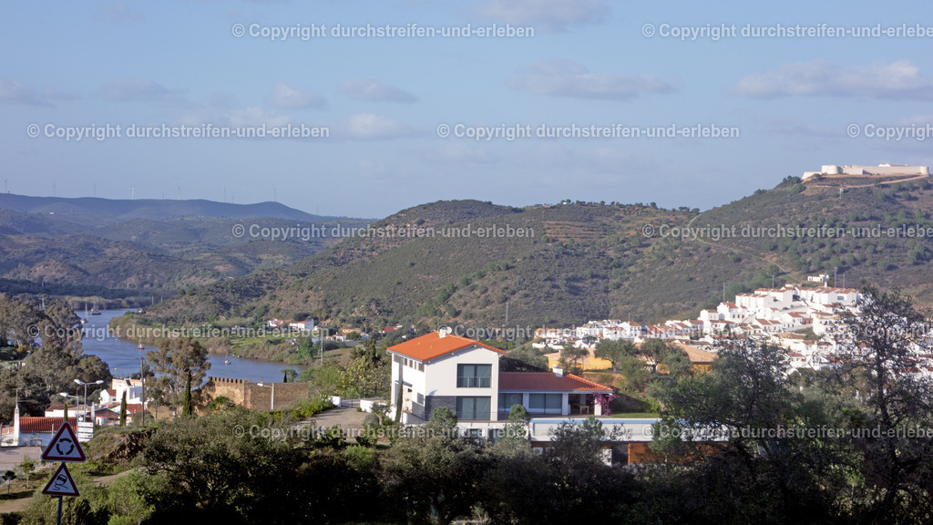 Blick von Alcoutim auf die Umgebung am Rio Gudiana | Blick von Alcoutim auf die Umgebung am Rio Gudiana: Alcoutim ist eine Kleinstadt und ein Kreis mit 2523 Einwohnern in Portugal, im Distrikt Faro. Sie liegt im äußersten Nordosten der Algarve am hier zu sehenden Grenzfluss Guadiana. Auf der anderen Seite liegt Spanien mit Sanlucar del Guadiana und mittelalterlicher Burg. - Realisiert mit Pictrs.com