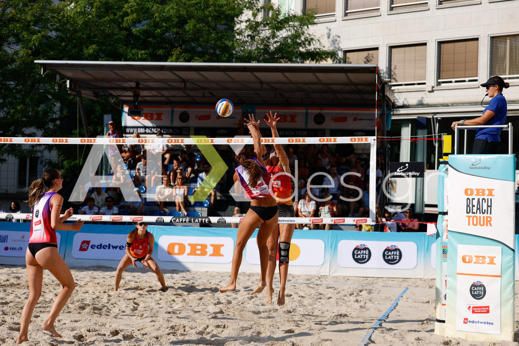 Obi BeachTour 2026 - Basel | BASEL, SWITZERLAND - JULY 17: FIONA PROBST (SUI) attack / spike against JASMINE WANDELER (SUI) block during the Obi BeachTour 2026 match between WANDELER / STOLZ (SUI) and GRÜNIG / PROBST (SUI) at Barfüsserplatz on July 17, 2026 in Basel, Switzerland. - Realisiert mit Pictrs.com